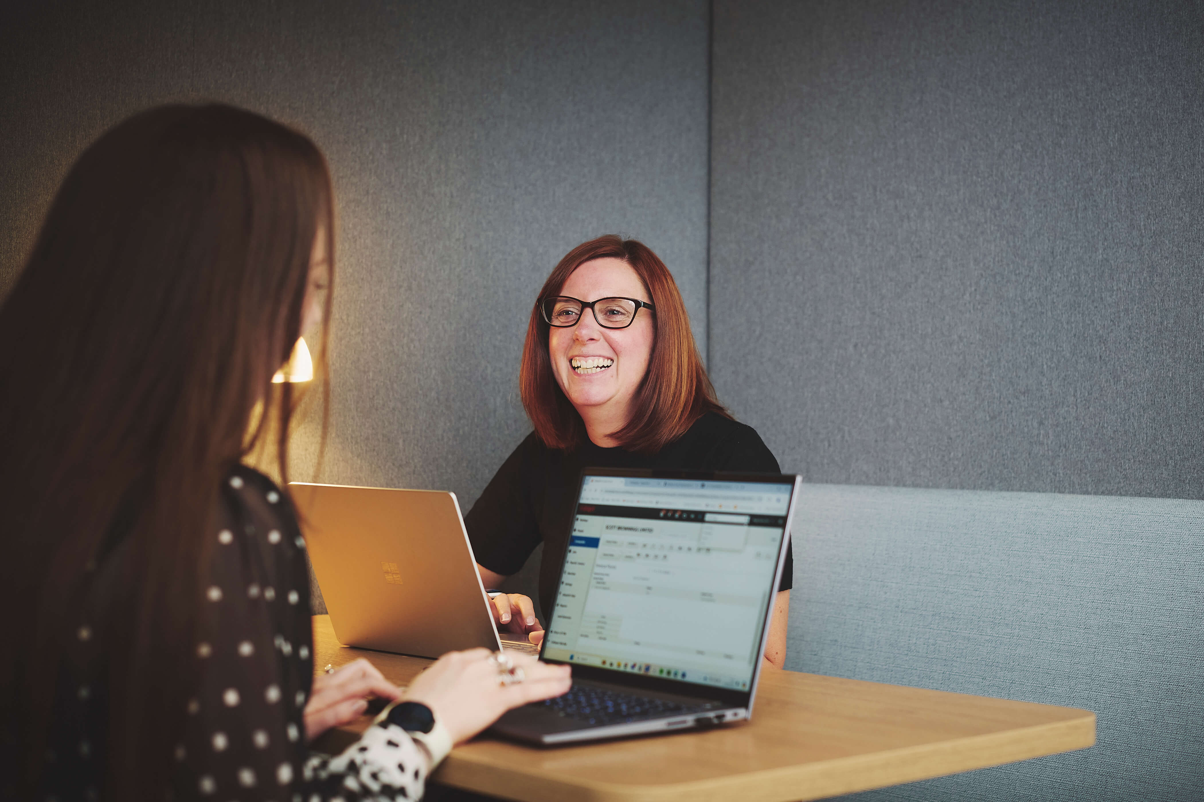 Female office workers laughing