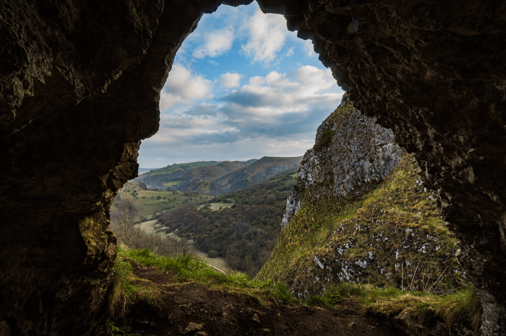 View of lush landscape from cave